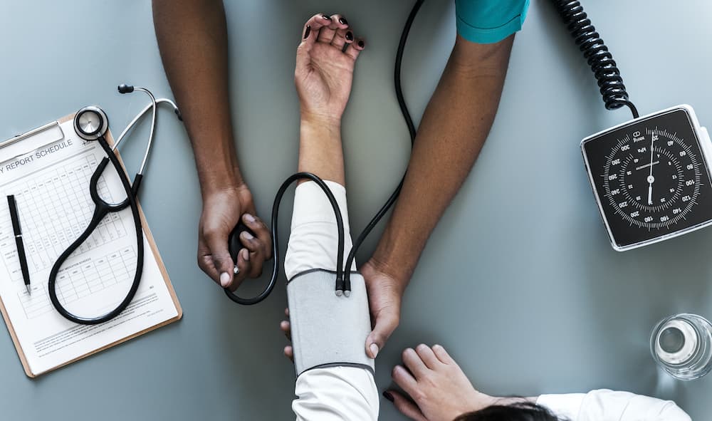 Nurse measuring patient blood pressure iRhythm technologies awarded NHS funding to advance cardiac care