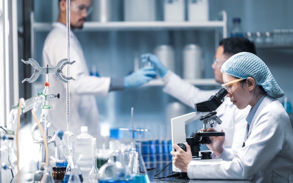Health care researchers working in life science laboratory Smart glasses aid university research