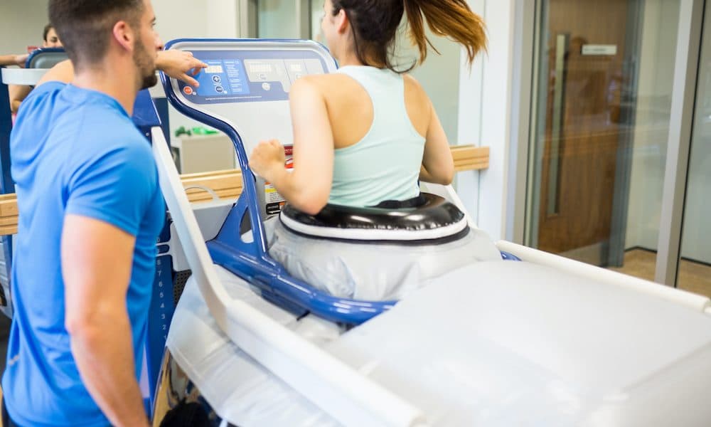 Woman,Using,An,Anti,Gravity,Treadmill,Beside,Trainer,At,The How health tech can transform the post-acute care market