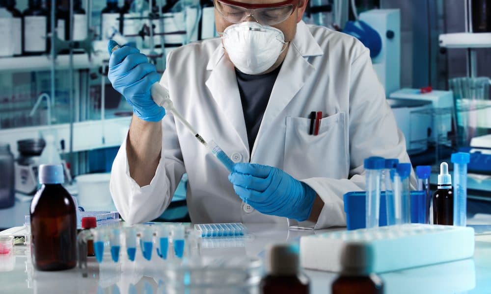 scientist pipetting tube test in the research laboratory Partners aim to remove clinical trials bottleneck
