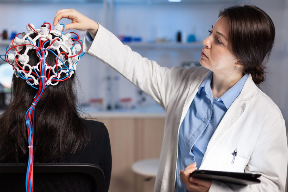 Back view of woman patient wearing performant eeg headset MHRA issues guidance on safe development of phage therapies