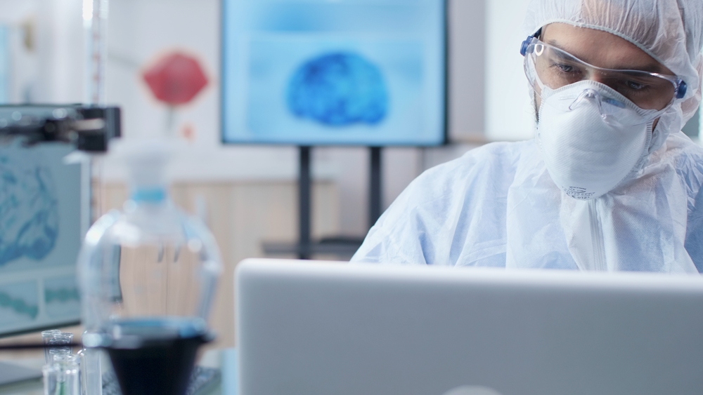 chemist-researcher-doctor-analyzing-brain-activity-typing-medical-expertise-laptop-computer-microbiology-experiment-scientist-man-with-ppe-equipment-working-biochemistry-laboratory Global AI challenge tests Covid drug discovery