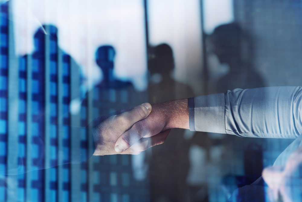 handshaking-business-person-office-concept-teamwork-partnership-double-exposure Illumina completes acquisition of SomaLogic